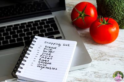Photo of shopping list with computer and tomatoes.