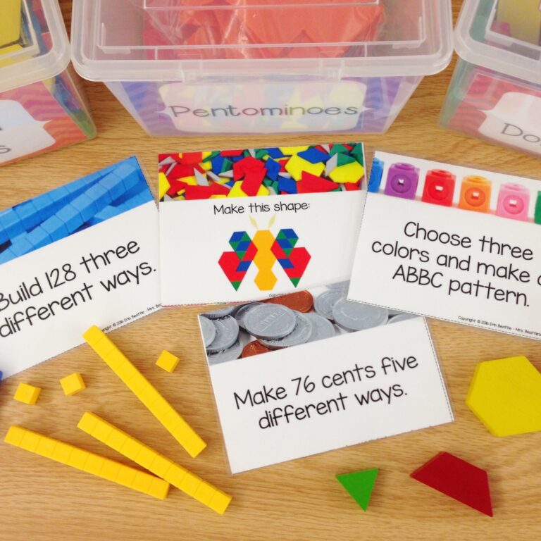 Photo of math morning work task cards on a student desk with manipulatives and bins.