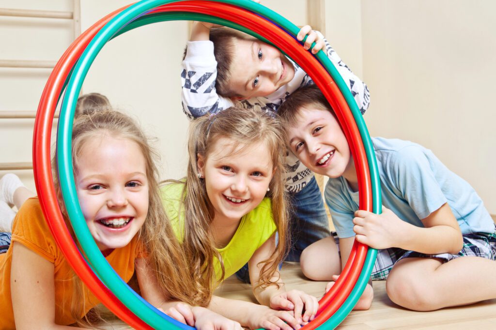 Children looking through hula hoops